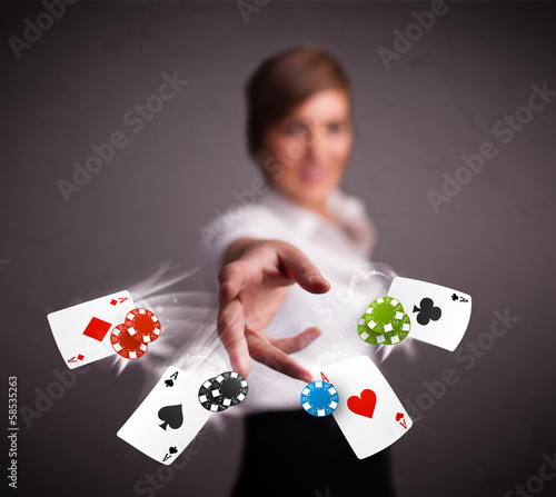 Young woman playing with poker cards and chips