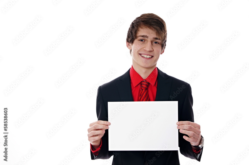 Young businessman holds the paper in front of him Young businessman holds the paper in front of him