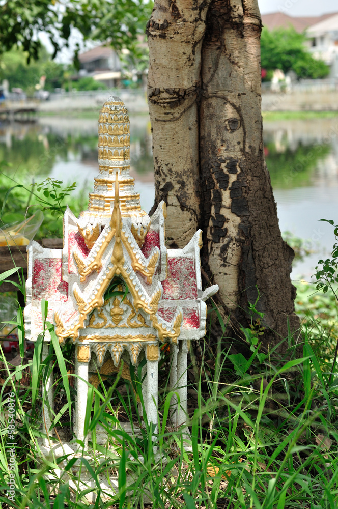 Fototapeta premium shrine of the household god beside tree.