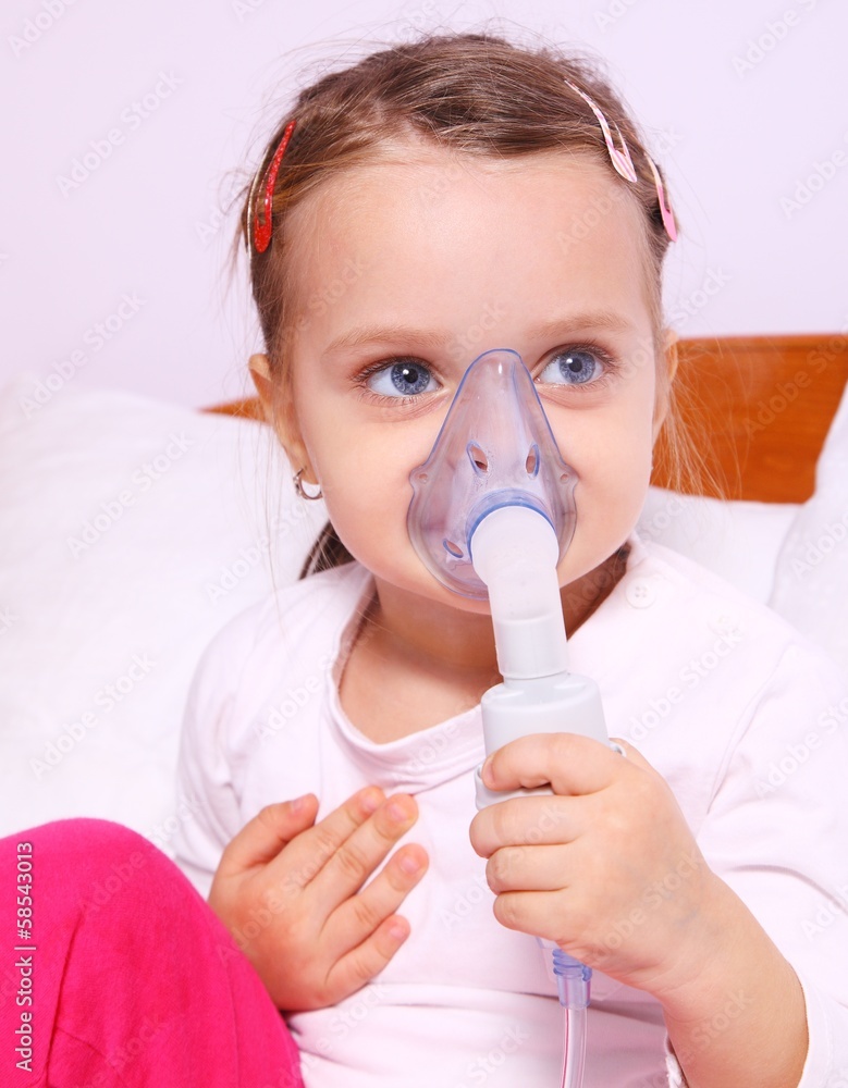 Little girl making aerosol treatment