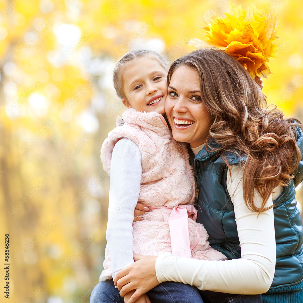 mother and daughter playing in autumn park mother and daughter playing in autumn park