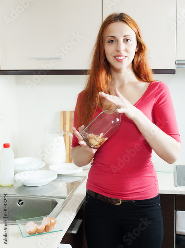 Positive woman cleaning glass bottle