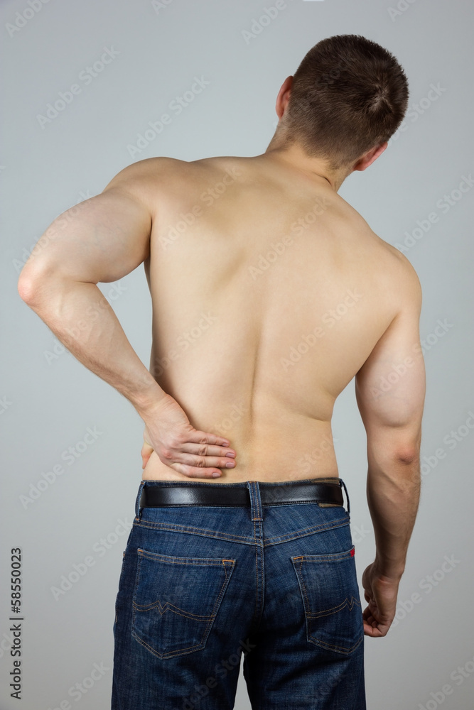 Young man with back pain Young man with back pain