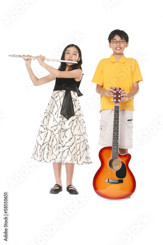 Full body brother and sister playing transverse flute