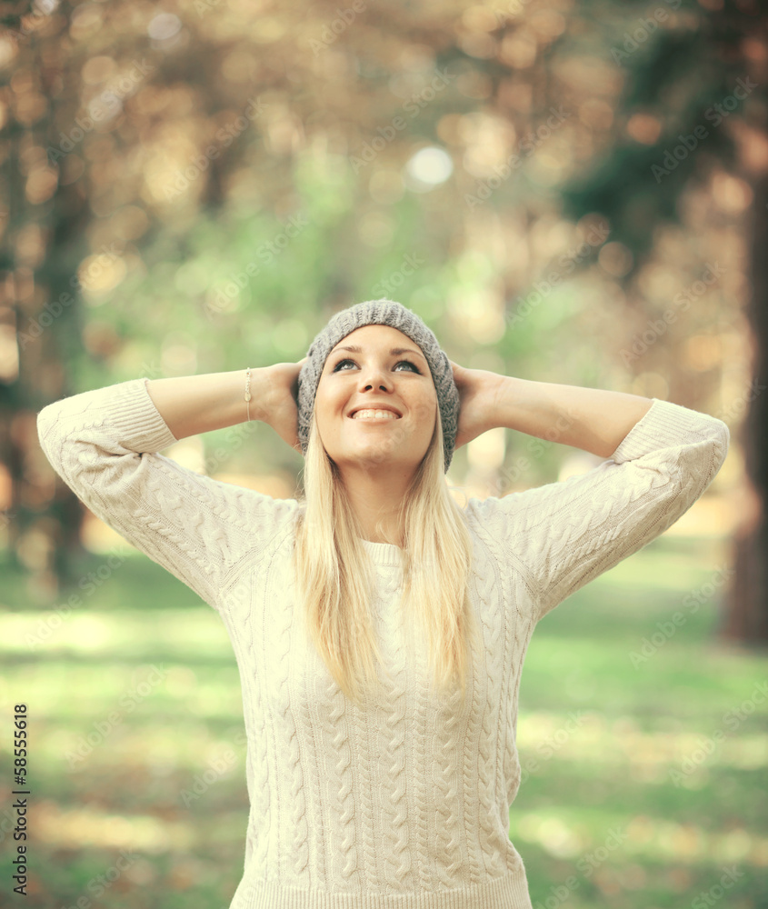 Happy woman looking up in the sky in Autumn forest Happy woman looking up in the sky in Autumn forest