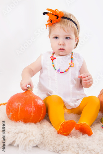 Baby girl with pumpkin