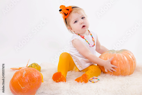 Baby with pumpkins