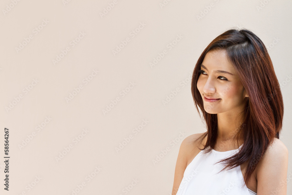 smiling happy woman looking at blank background, warm brown beig smiling happy woman looking at blank background, warm brown beig