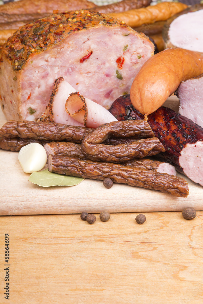 cured meat products on a wooden table cured meat products on a wooden table