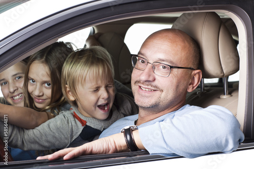 huppy father with children in a car