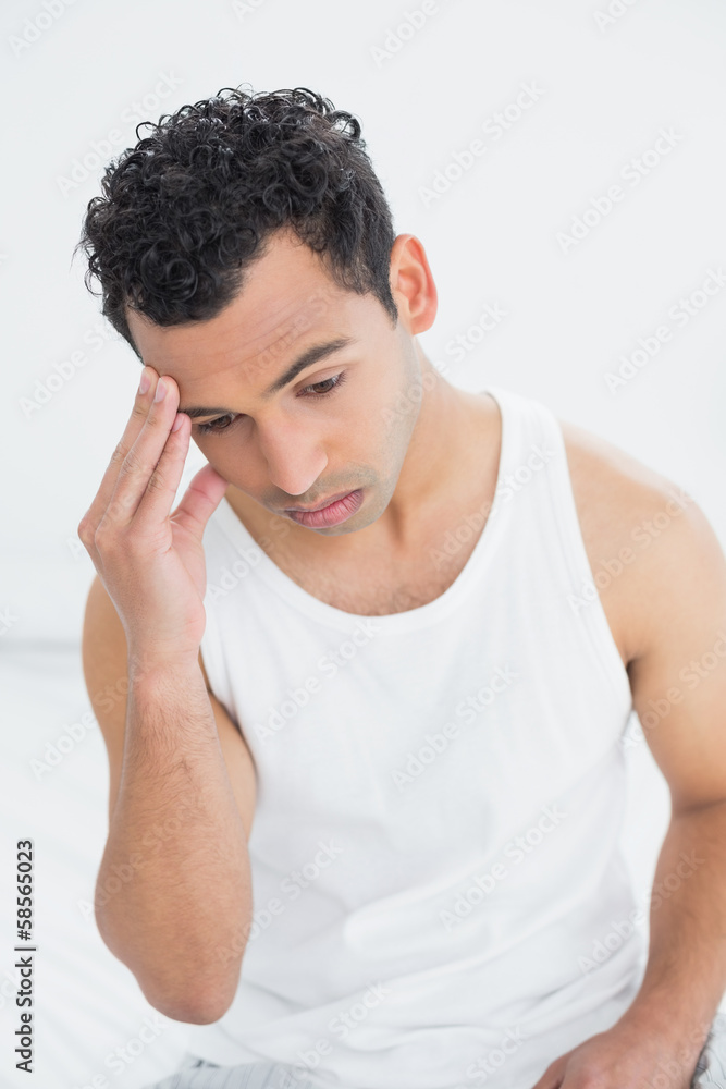 Man suffering from headache in bed Man suffering from headache in bed