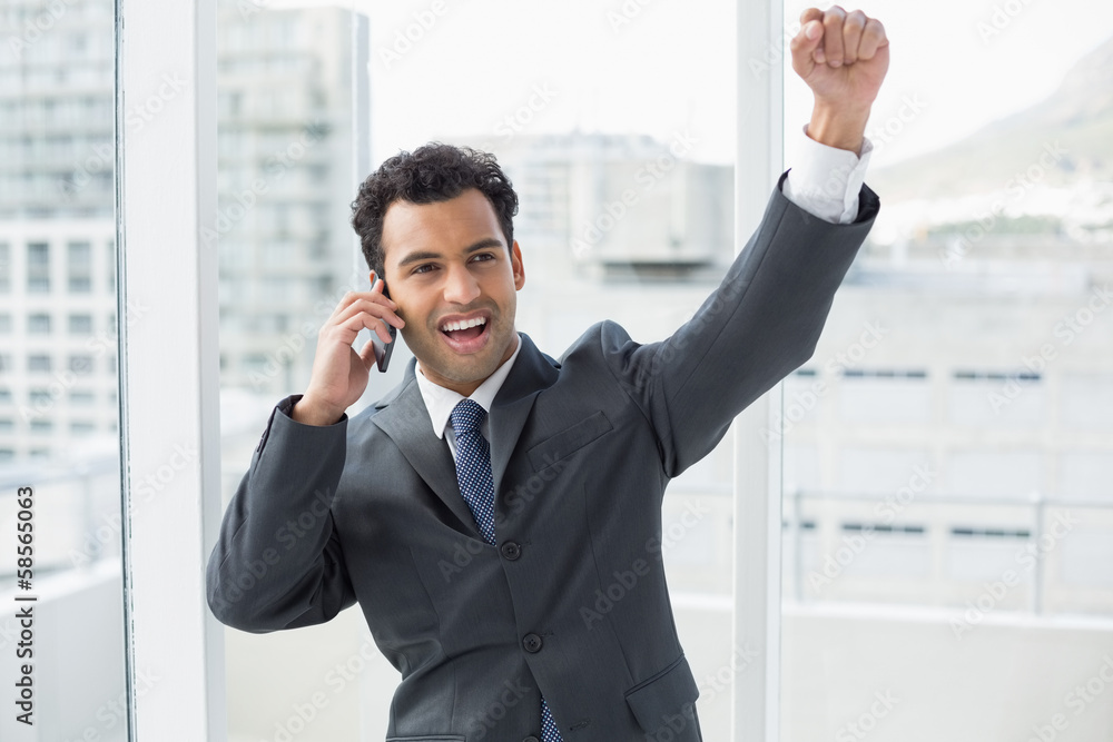 Cheerful elegant businessman using cellphone in office Cheerful elegant businessman using cellphone in office