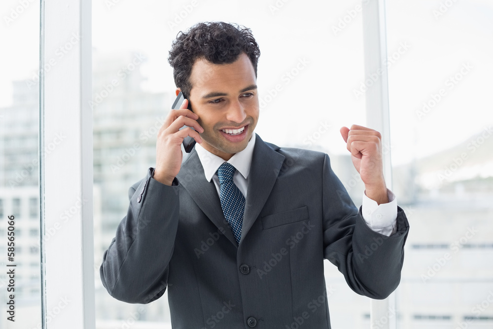 Elegant young businessman using cellphone in office Elegant young businessman using cellphone in office