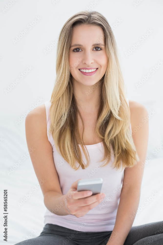 Beautiful smiling woman text messaging in bed Beautiful smiling woman text messaging in bed