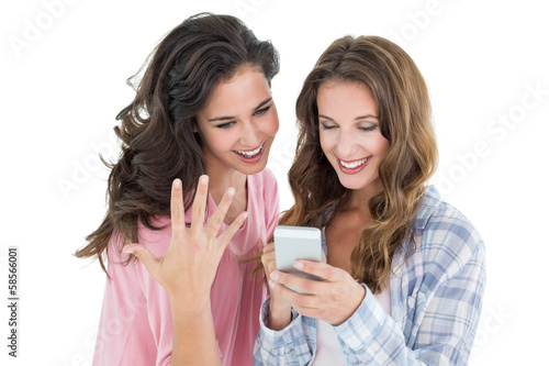 Female friends looking at mobile phone