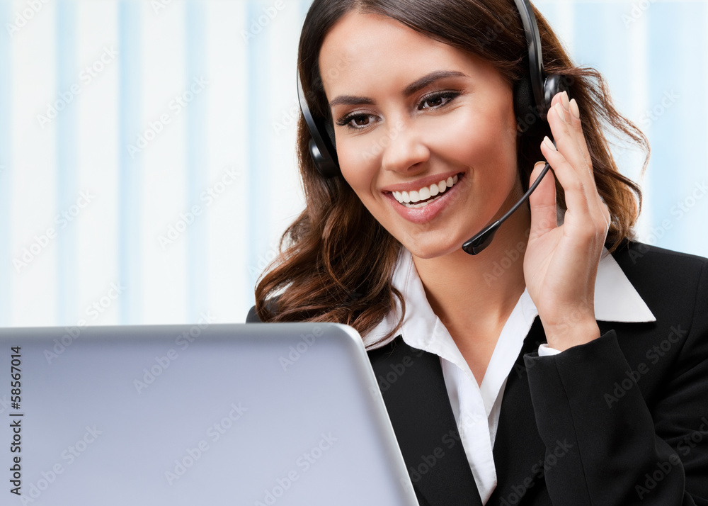 Support phone operator in headset, working with laptop Support phone operator in headset, working with laptop