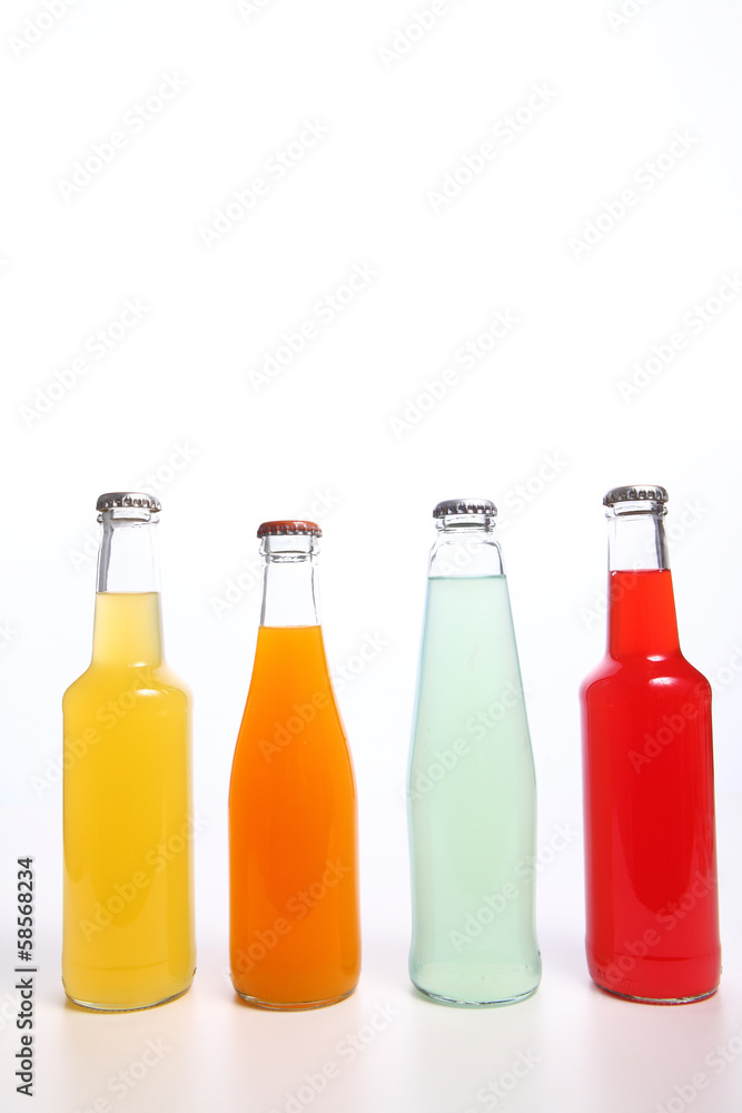 Four assorted soda bottles on white Four assorted soda bottles on white