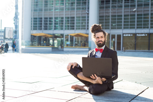 Stylish elegant dreadlocks businessman using notebook photo