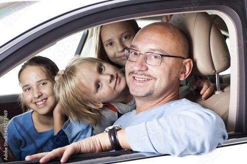 huppy father with children in a car