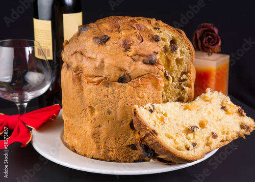 Delicious whole panettone, Christmas cake with glass, red wine,
