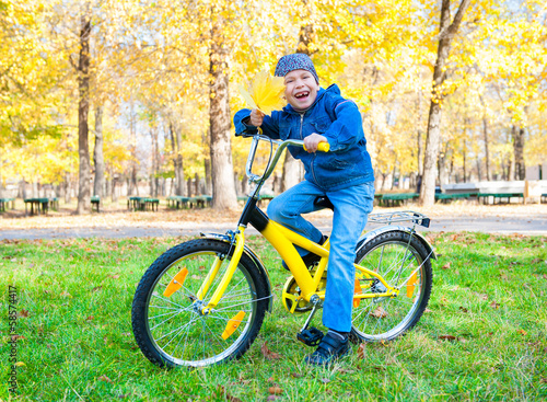 boy rides a bicycle in park photo