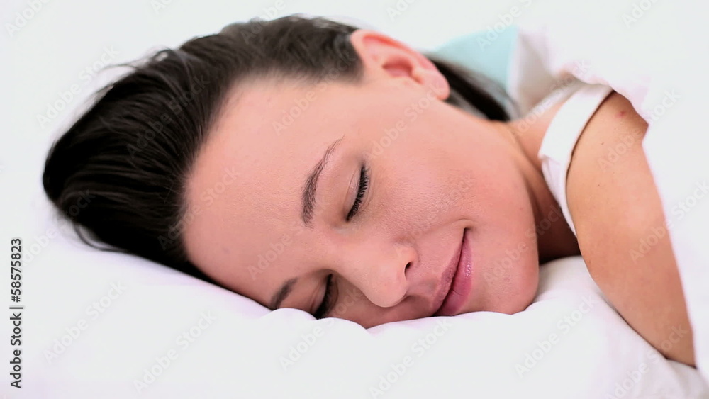 Calm beautiful woman lying in her bed under the cover Calm beautiful woman lying in her bed under the cover