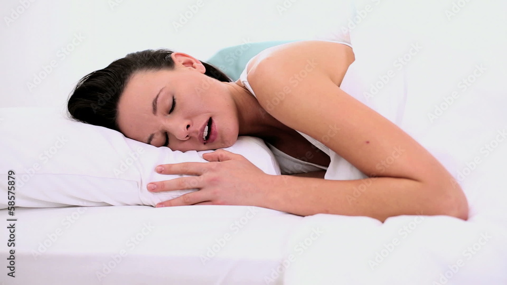 Peaceful attractive woman sleeping lying in her bed Peaceful attractive woman sleeping lying in her bed