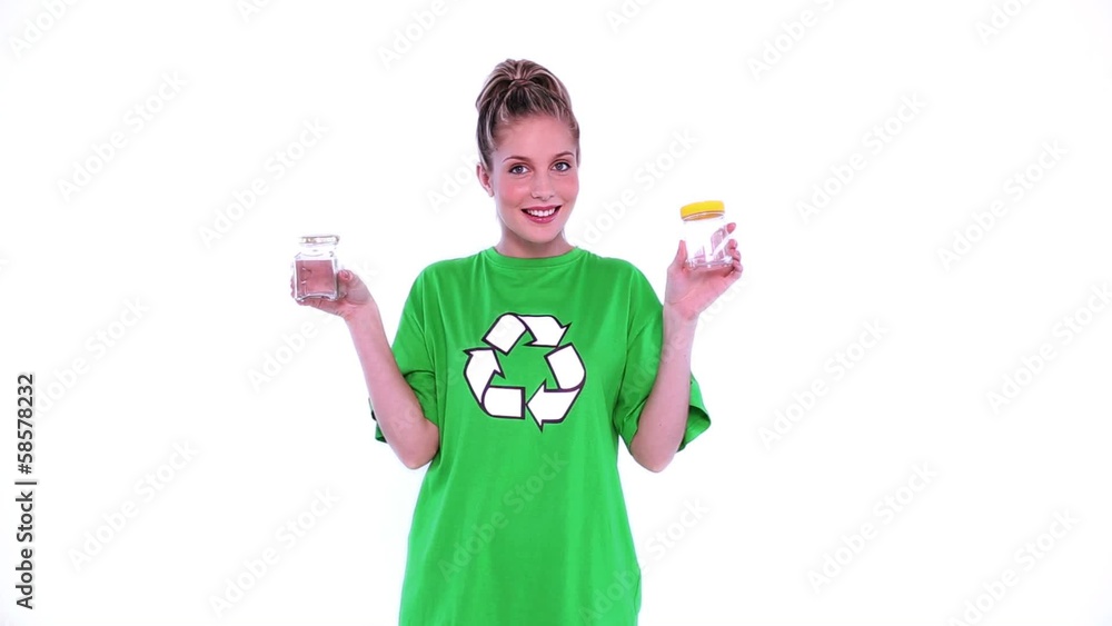 Cheerful female environmental activist showing two jam jars Cheerful female environmental activist showing two jam jars