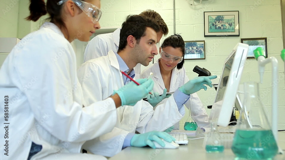 Science students working on an experiment together Science students working on an experiment together
