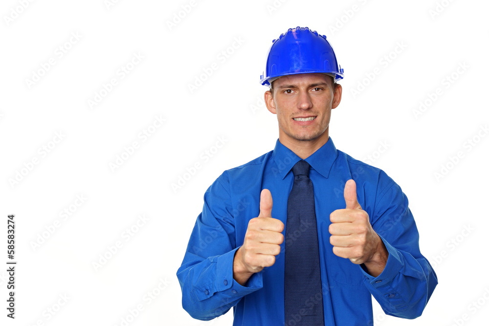 Young businessman a helmet shows fingers up.