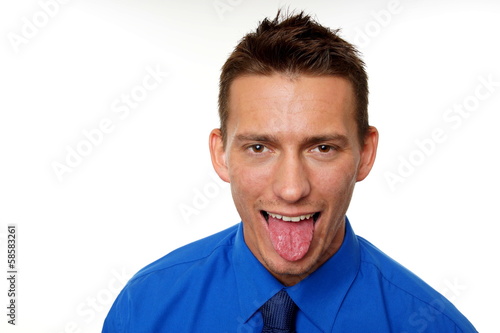 Young man at blue shirt and his tongue