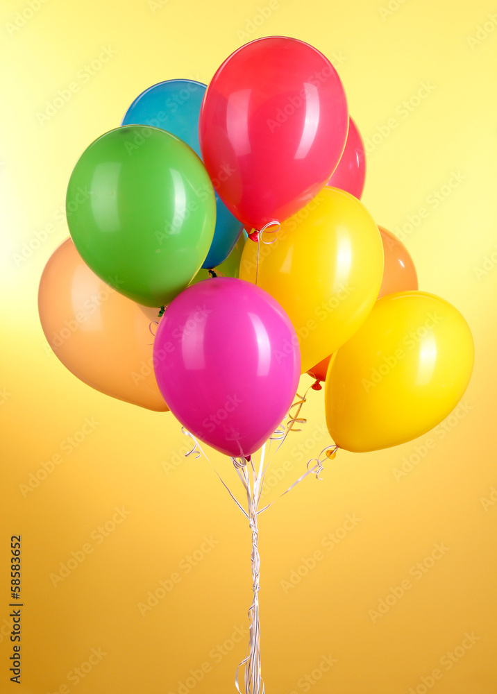 Colorful balloons on yellow background Colorful balloons on yellow background