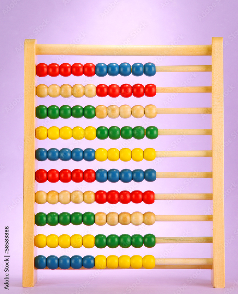 Bright wooden toy abacus, on purple background Bright wooden toy abacus, on purple background