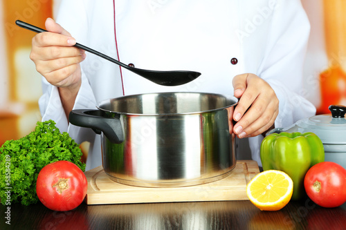 Cook hands and pan at workplace