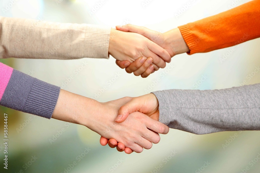 Handshakes on bright background Handshakes on bright background