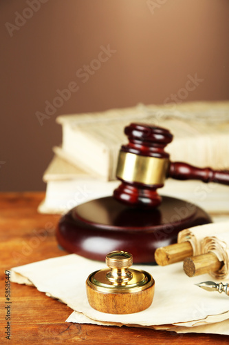 Wooden stamp, gavel and old papers on wooden table