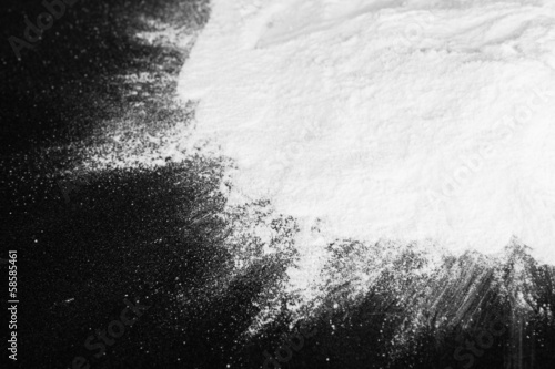 Heap of powdered sugar on black background photo