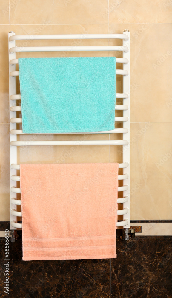 Fototapeta premium Color towels on radiator in bathroom