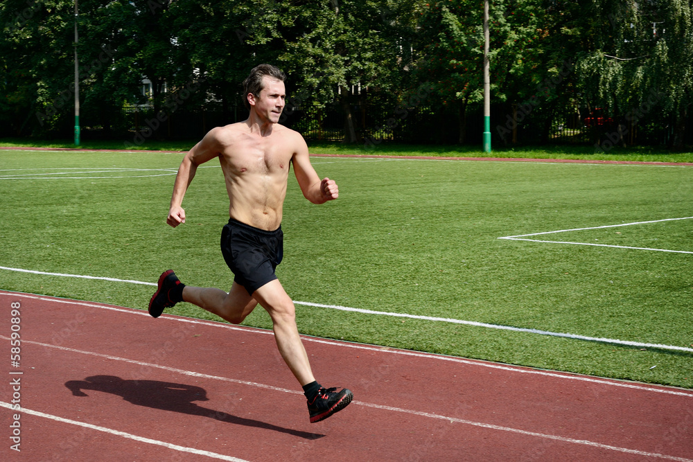Athlete runner trains at the stadium