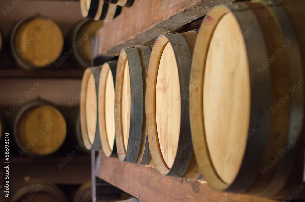 Wine barrels stacked in the cellar.