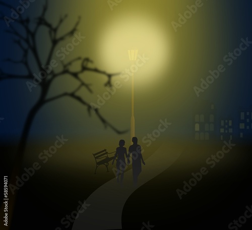 Couple walking at night under a lantern in misty park