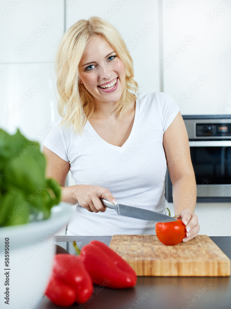 Woman cooking in her kitchen with vegetables Woman cooking in her kitchen with vegetables