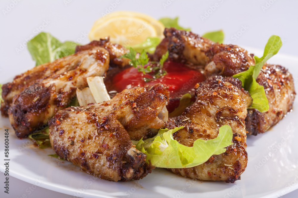fried chicken wings in sauce with lemon and tomato sauce