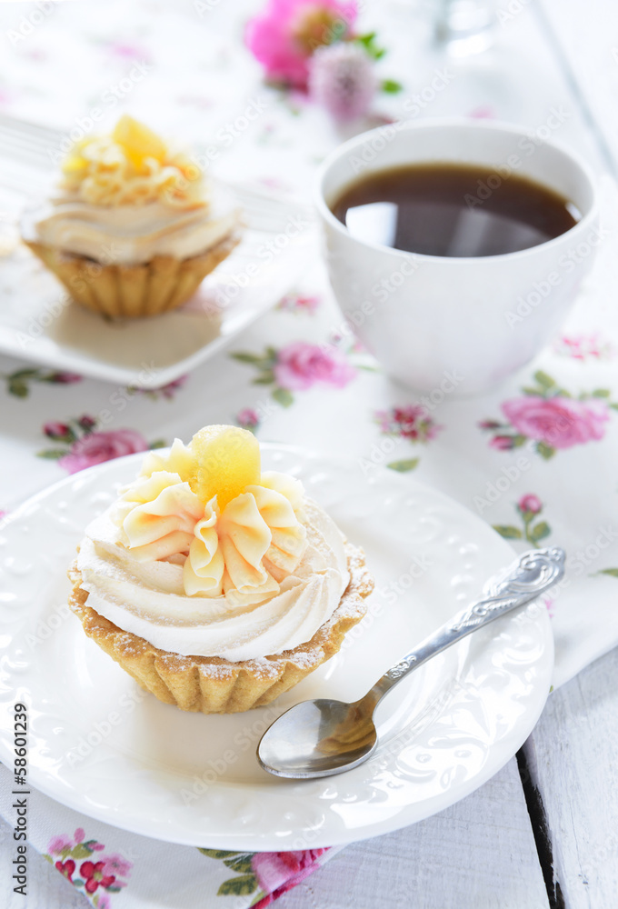 Tart with whipped cream and a cup of tea on the table Tart with whipped cream and a cup of tea on the table