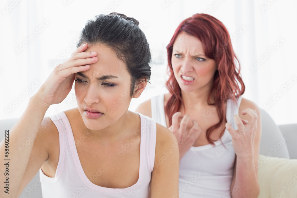 Angry young female friends having an argument Angry young female friends having an argument