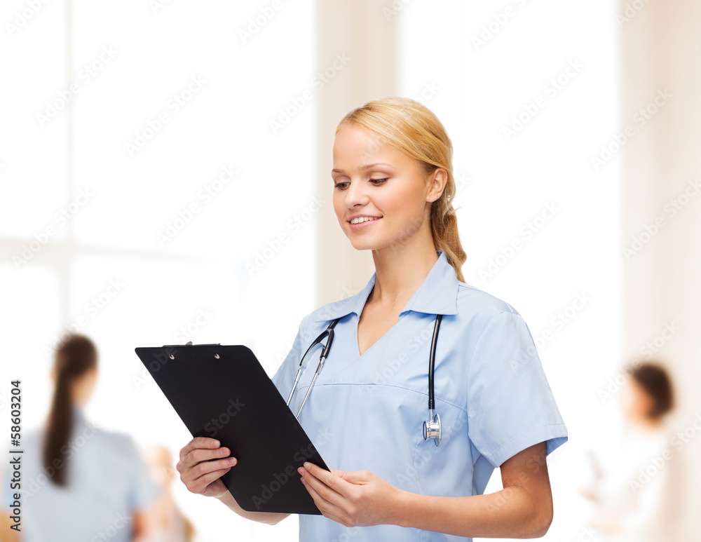 smiling female doctor or nurse with clipboard smiling female doctor or nurse with clipboard