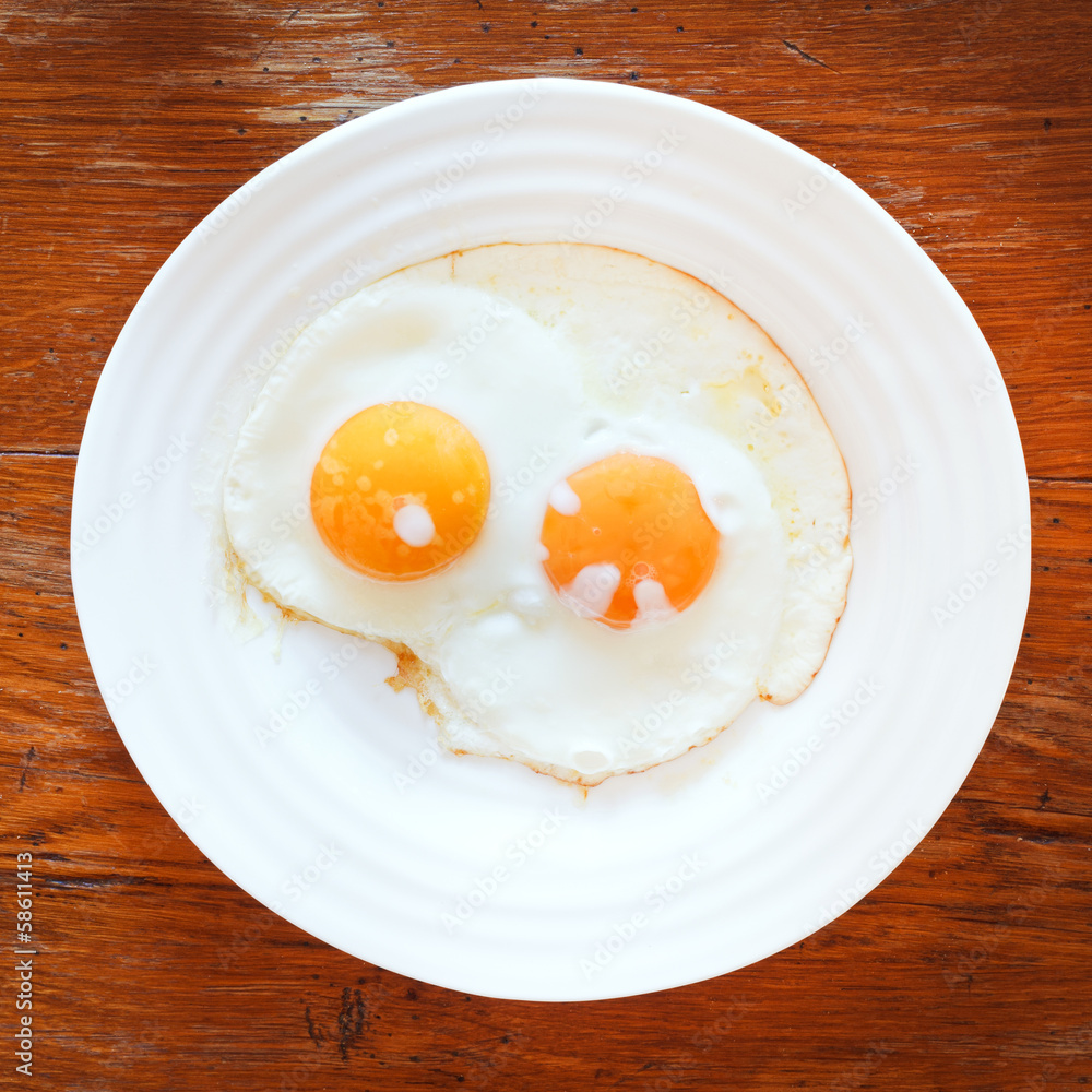 breakfast with two fried eggs in white plate breakfast with two fried eggs in white plate
