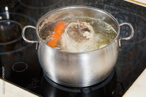 simmering chicken soup with seasoning vegetables