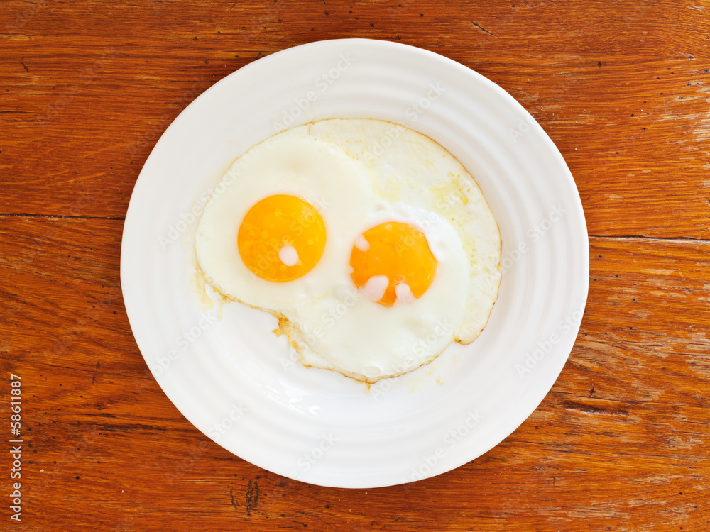 breakfast with two fried eggs in white plate breakfast with two fried eggs in white plate