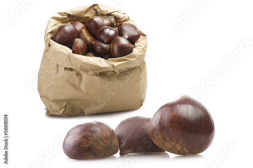 fresh group of chestnuts in a paper bag with three out